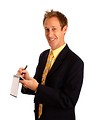 Free Stock Photo: A young businessman in a suit writing on a notepad