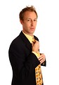 Free Stock Photo: A young businessman in a suit adjusting his tie