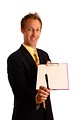 Free Stock Photo: A young businessman in a suit holding a clipboard and pen