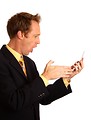 Free Stock Photo: A young businessman in a suit screaming at a cell phone