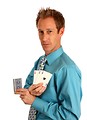 Free Stock Photo: A young businessman holding a hand of playing cards