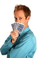 Free Stock Photo: A young businessman holding a hand of playing cards