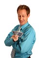 Free Stock Photo: A young businessman holding a hand of playing cards