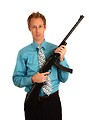 Free Stock Photo: A young businessman holding a rifle