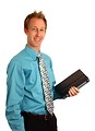 Free Stock Photo: A young businessman holding a binder