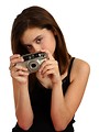 Free Stock Photo: A cute young girl taking a picture with a camera