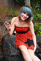 Free Stock Photo: A beautiful young woman posing in a red dress on rocks