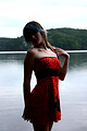 Free Stock Photo: A beautiful young woman posing in a red dress by a lake