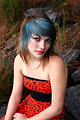 Free Stock Photo: A beautiful young woman posing in a red dress on rocks