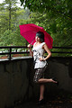Free Stock Photo: A beautiful young woman posing with an umbrella