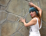 Free Stock Photo: A beautiful young woman posing against a stone wall