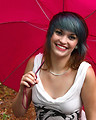 Free Stock Photo: A beautiful young woman posing with an umbrella