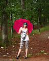 Free Stock Photo: A beautiful young woman posing with an umbrella