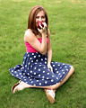 Free Stock Photo: A beautiful young girl holding an apple in the grass