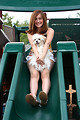 Free Stock Photo: A beautiful young girl playing on a playground with a dog