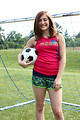 Free Stock Photo: A cute young girl posing with a soccer ball