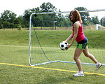 Free Stock Photo: A cute young girl kicking a soccer ball.