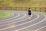 Free Stock Photo: A cute young girl running on a track field