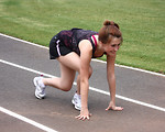 Free Stock Photo: A cute young girl on a track field preparing to race