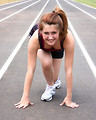 Free Stock Photo: A cute young girl on a track field preparing to race