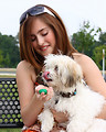 Free Stock Photo: A young girl feeding water to a small dog