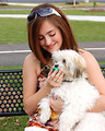 Free Stock Photo: A young girl feeding water to a small dog