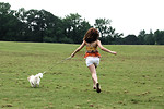 Free Stock Photo: A cute young girl running with her dog