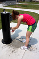 Free Stock Photo: A young girl washing her hands in a park