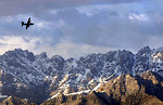 Free Stock Photo: A military airplane flying over mountains