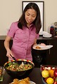 Free Stock Photo: A young Asian woman serving herself food from a table