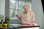 Free Stock Photo: An elderly woman preparing fresh fish
