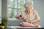 Free Stock Photo: An elderly woman preparing fresh fish