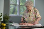 Free Stock Photo: An elderly woman preparing fresh fish