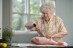Free Stock Photo: An elderly woman preparing fresh fish