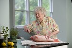 Free Stock Photo: An elderly woman preparing fresh fish