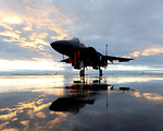 Free Stock Photo: An F-15E fighter jet on a runway at sunset