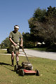 Free Stock Photo: A man mowing a lawn