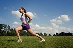 Free Stock Photo: A young woman stretching outdoors before exercising