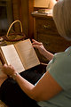 Free Stock Photo: A woman reading a book in her home