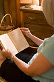 Free Stock Photo: A woman reading a book in her home