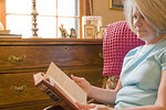 Free Stock Photo: A woman reading a book in her home