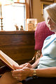 Free Stock Photo: A woman reading a book in her home