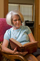 Free Stock Photo: A woman reading a book in her home