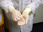 Free Stock Photo: A lab technician preparing to remove disposable gloves