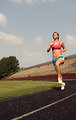 Free Stock Photo: A healthy young woman running outdoors on a track