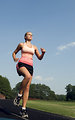 Free Stock Photo: A healthy young woman running outdoors on a track