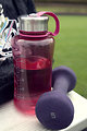 Free Stock Photo: A water bottle and weight on a bench outdoors