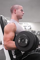 Free Stock Photo: A healthy young man lifting weights in a gym