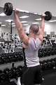 Free Stock Photo: A healthy young man lifting weights in a gym