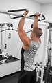 Free Stock Photo: A healthy young man performing pull-ups in a gym